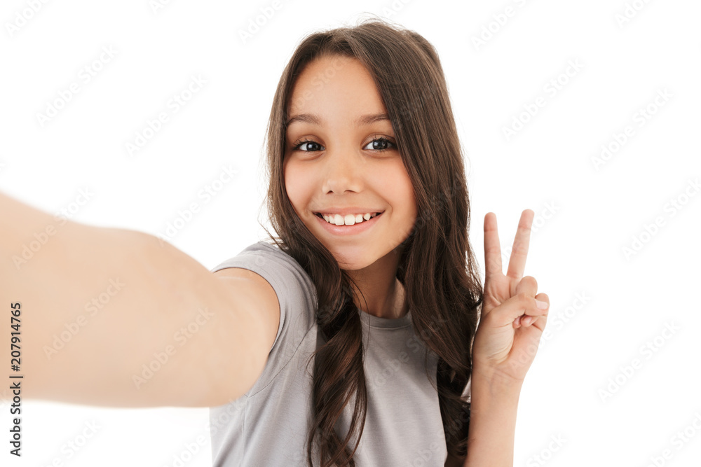 Pretty cute girl make selfie looking camera showing peace gesture. Pretty cute girl make selfie looking camera showing peace gesture.