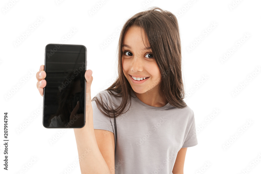 Cute girl standing isolated showing display of mobile phone. Cute girl standing isolated showing display of mobile phone.