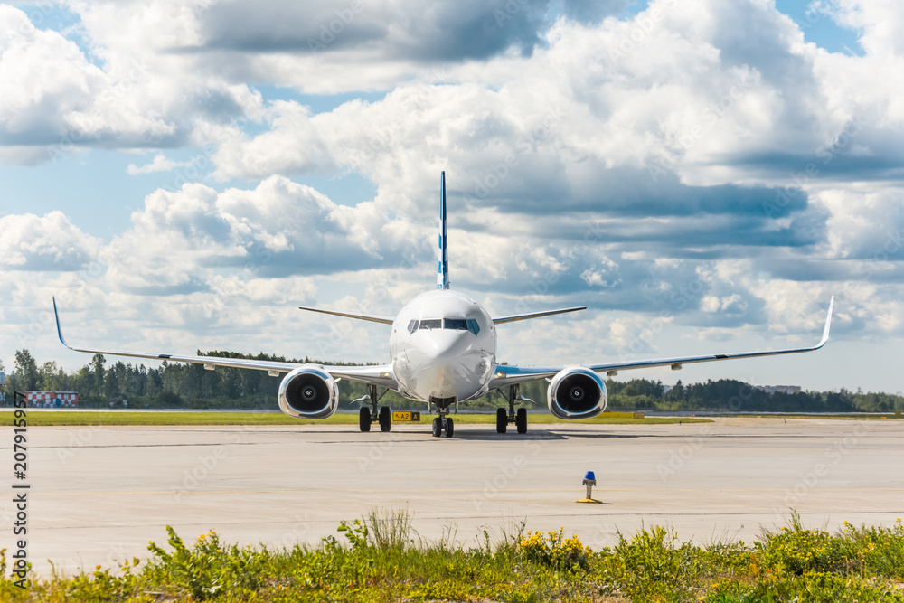 Aircraft on the steering track at the airport, exactly in the middle in the frame, against the backdrop of a picturesque sky in the clouds. Aircraft on the steering track at the airport, exactly in the middle in the frame, against the backdrop of a picturesque sky in the clouds.