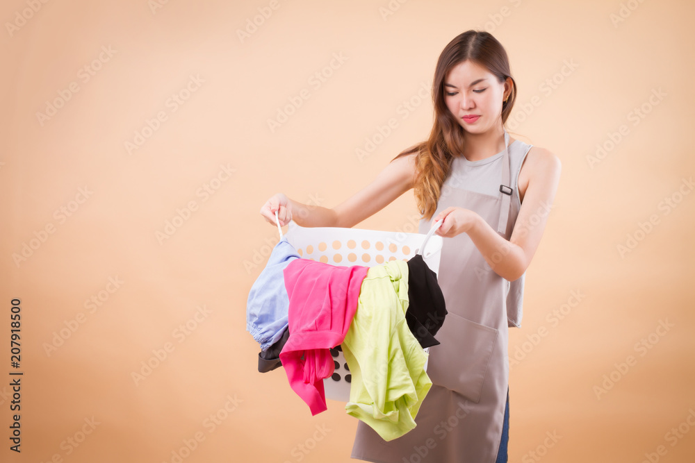 unhappy girl carrying stink heavy dirty cloth, disgusting laundry basket; woman housekeeper, sad girl maid holding filthy bad smell laundry basket woman portrait; hard work, dirty job, bad job concept unhappy girl carrying stink heavy dirty cloth, disgusting laundry basket; woman housekeeper, sad girl maid holding filthy bad smell laundry basket woman portrait; hard work, dirty job, bad job concept