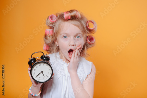 Portrait of the girl who is late in school. Portrait of the girl who is late in school.Happy funny child little girl with hair curlers