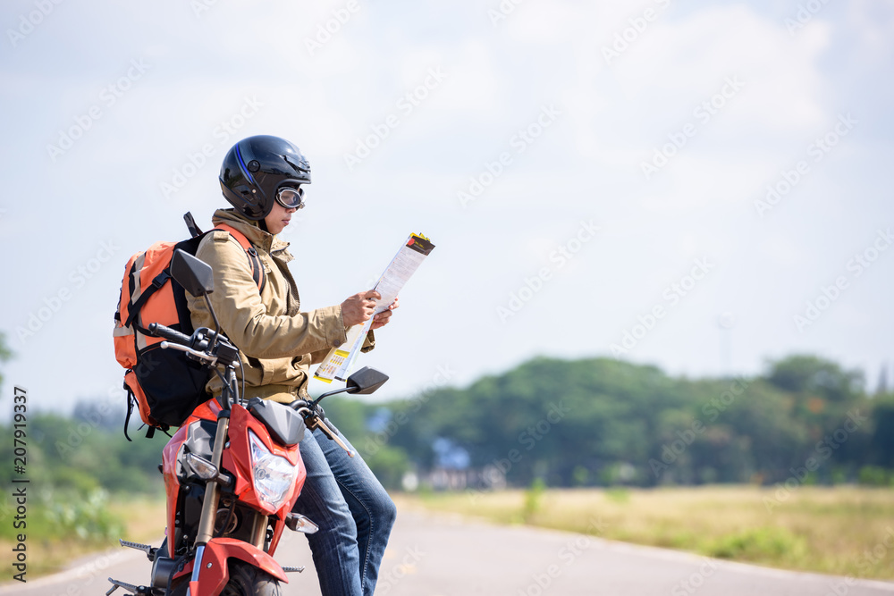 Travelers or backpackers reading maps on motorbikes for travel. Travelers or backpackers reading maps on motorbikes for travel.