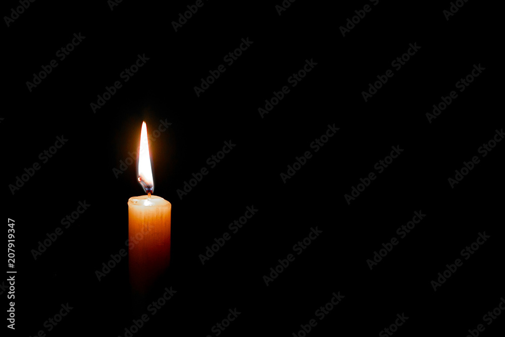 isolate burning candle on dark background isolate burning candle on dark background