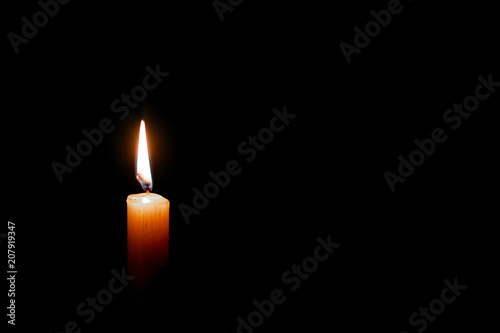 isolate burning candle on dark background