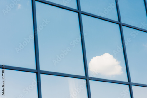 Sky and clouds reflection in the windows of modern office building
