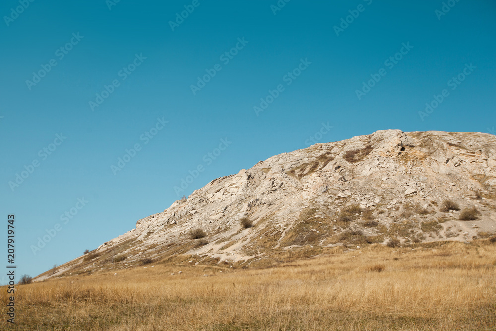 A beautiful mountain of yellow on a blue sky background in the summer A beautiful mountain of yellow on a blue sky background in the summer