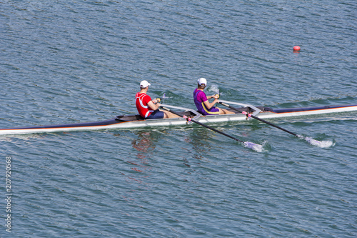 Two young rowers in a racing rower boat