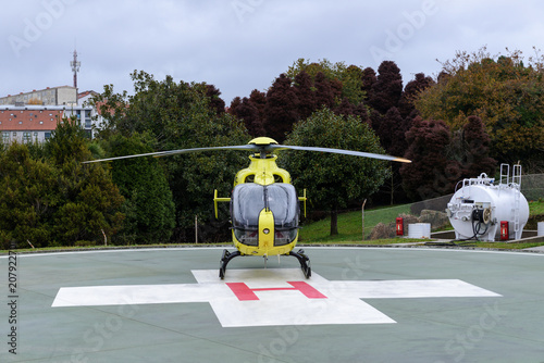 yellow helicopter on helipad
