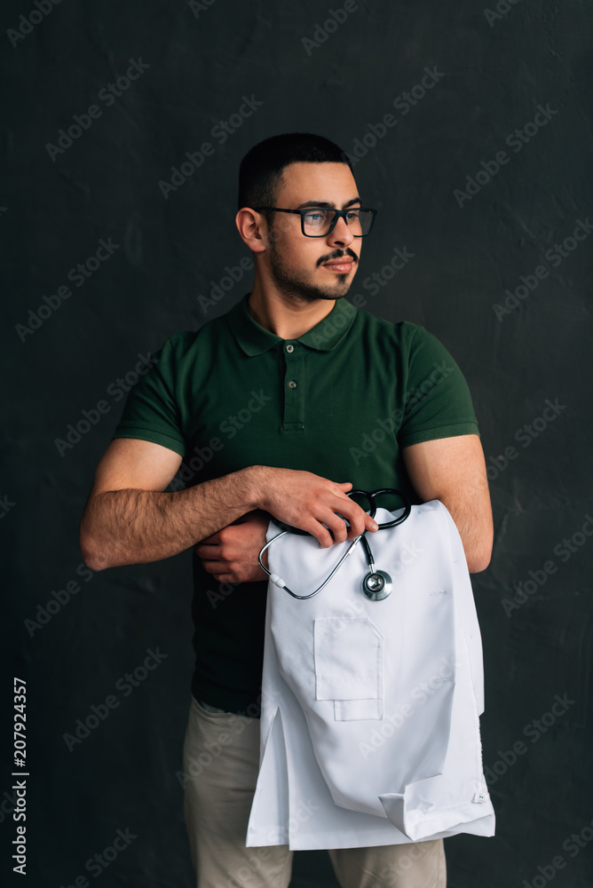 Portrait of medical specialist with stethoscope looking self confident