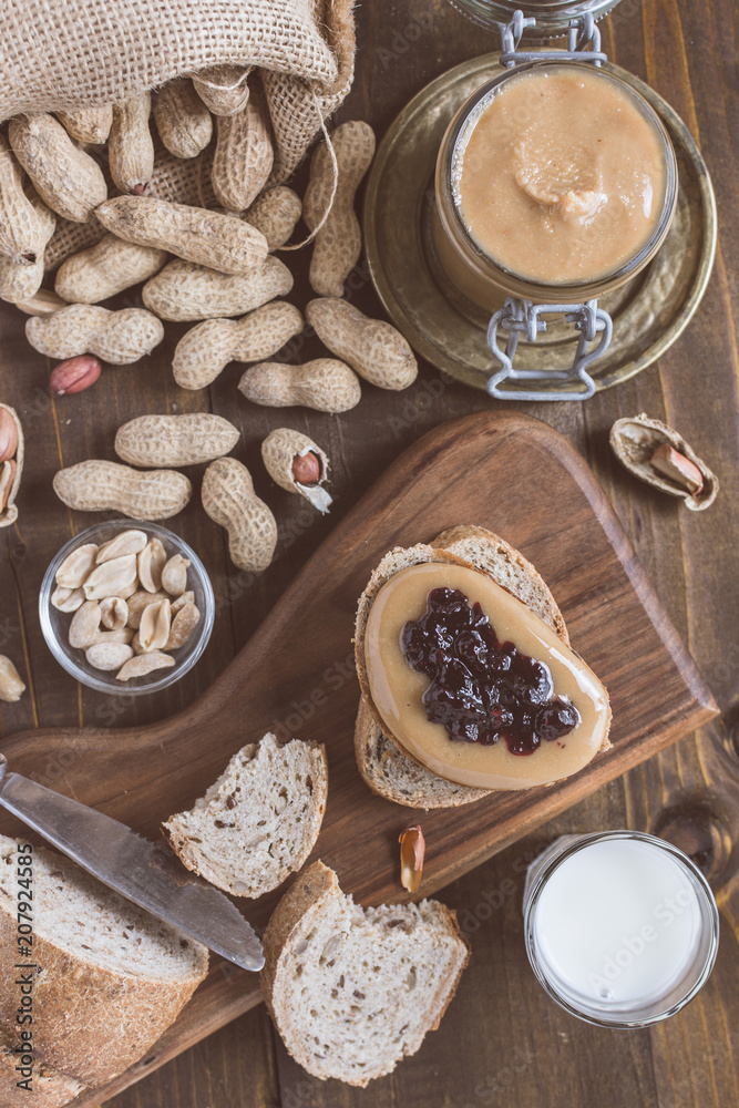 Peanut Butter and Jelly Sandwich on Rustic Wooden Cutting Board Peanut Butter and Jelly Sandwich on Rustic Wooden Cutting Board