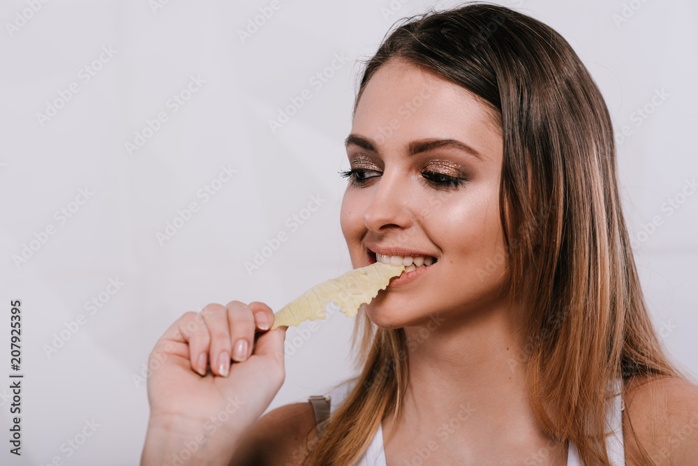 girl eating cabbage.she is showing healthy vegetables, healthcare and diet concept girl eating cabbage.she is showing healthy vegetables, healthcare and diet concept