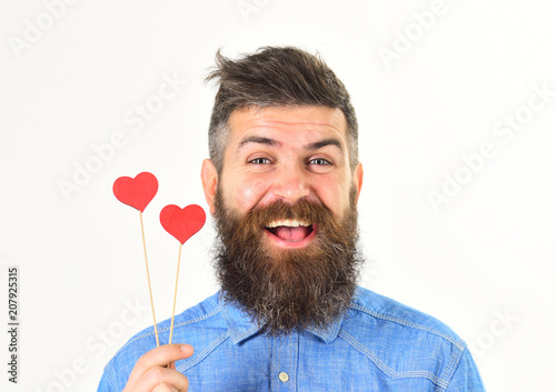handsome bearded man holding red heart symbol and smiling photo