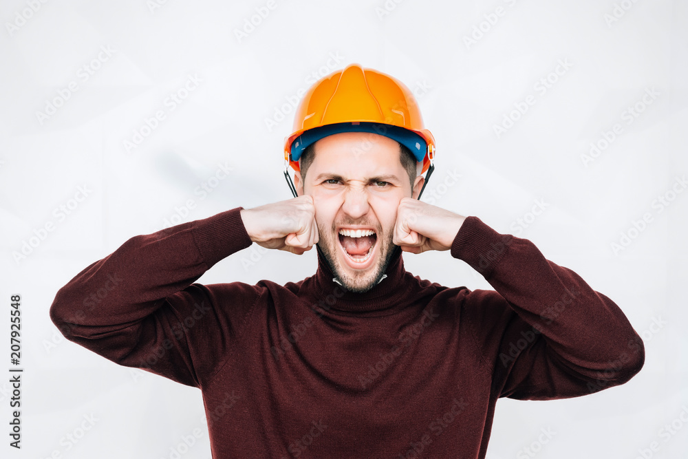 Happy smiling worker on a white background.Worker with orange helmet.Young handsome contractor isolated over white background Happy smiling worker on a white background.Worker with orange helmet.Young handsome contractor isolated over white background