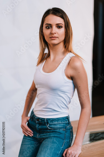 Thin girl in jeans and white shirt.Smiling schoolgirl
