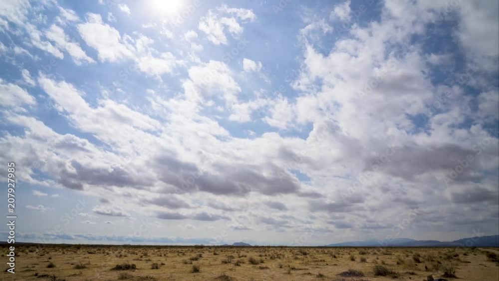 Sun shines over desert on cloudy day, Time Lapse Sun shines over desert on cloudy day, Time Lapse