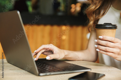 Close up of a woman typing on laptop computer