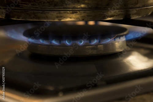 Close up of a lit gas burner on a tove top