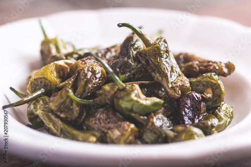 Green Padron Peppers with Olive Oil in Rustic White Plate. Pimientos de Padron.
