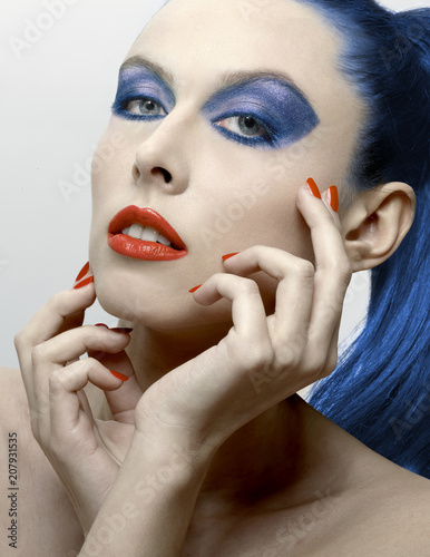 beautiful woman with blue eyes hair and eyeshadow and red lipstick and polish