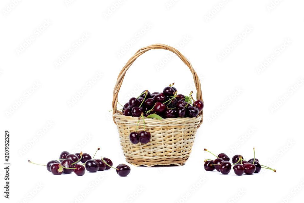 .Black cherry in a small basket on a white isolated background. .Black cherry in a small basket on a white isolated background.