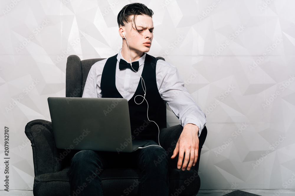 Businessman working on laptop computer at coworking office. Coworking open space.Attractive man in suit is using a laptop for work.
