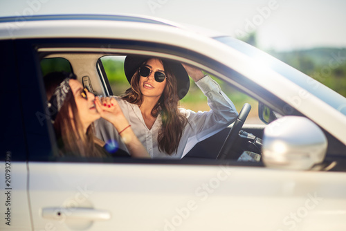 Two young women having fun driving © chika_milan