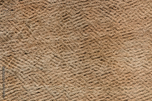 Brown sandstone wall texture details. Close-up photo of gritty background. Horizontal orientation