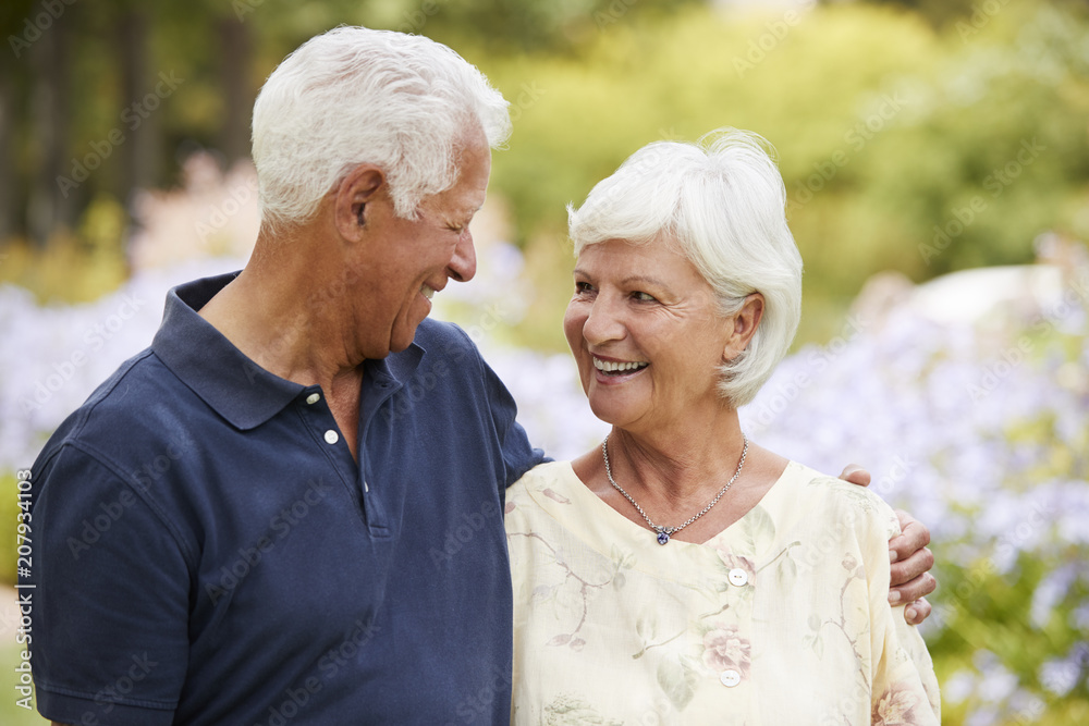 Senior Couple Enjoying Walk In Park Together Senior Couple Enjoying Walk In Park Together