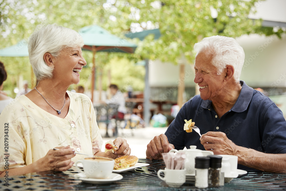 Portrait Of Senior Couple Enjoying Meal At Outdoor Cafe Portrait Of Senior Couple Enjoying Meal At Outdoor Cafe