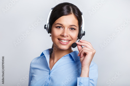 customer support phone operator in headset, with blank copyspace area for slogan or text message, over grey background. Consulting and assistance service call center.