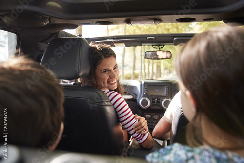 Family Driving In Open Top Car On Countryside Road Trip
