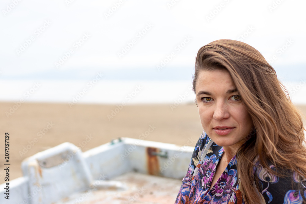 Ukrainian woman with colorful dress and print on the beach Ukrainian woman with colorful dress and print on the beach