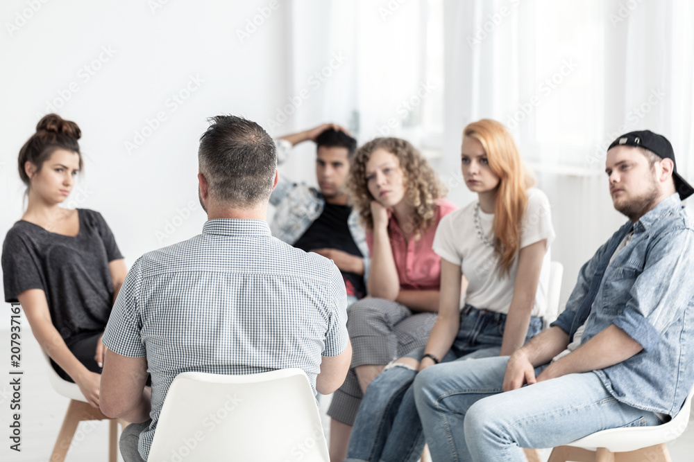 Group of young people talking with psychologist in the rehab center Stock  Photo | Adobe Stock