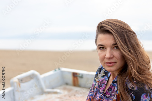 Ukrainian woman with colorful dress and print on the beach