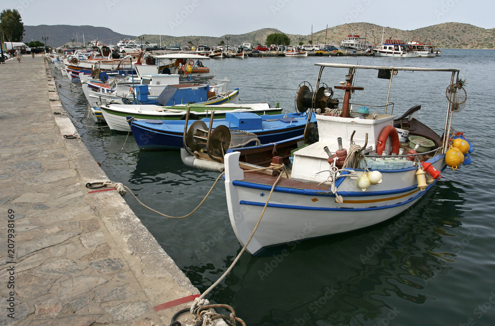 The landscape with white boats near the quay and far hills in the small Mediterranean town on the sunny day