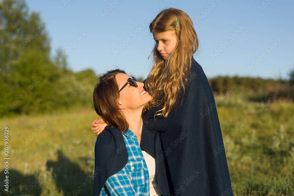 Portrait of parent and child. Mother hugs her little daughter. Portrait of parent and child. Mother hugs her little daughter.