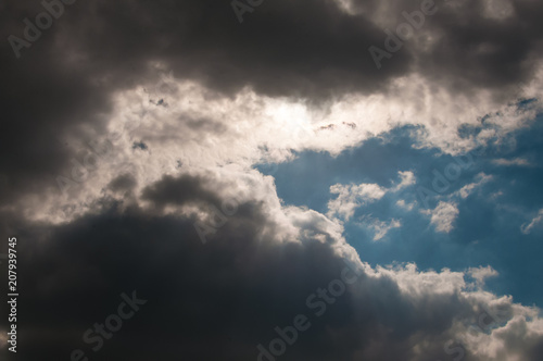 Beautiful, unusual sky. Blue clouds.The sun is behind the clouds.