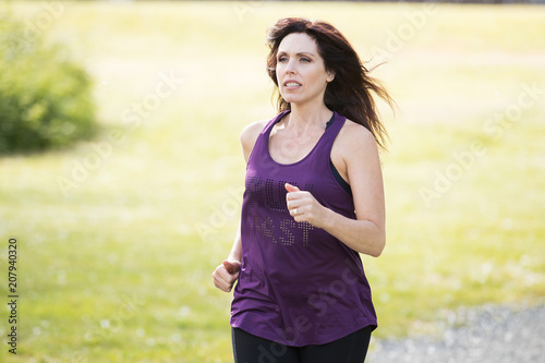 Fototapeta Naklejka Na Ścianę i Meble -  Strong, active woman running