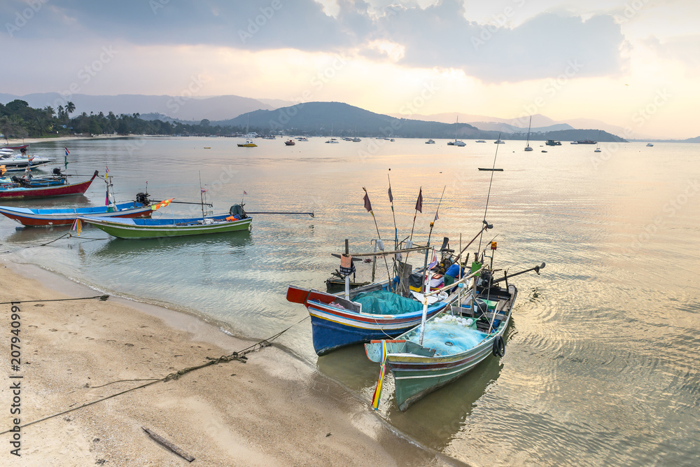 Traditional Thai fishing boats in the sunset  preparing for night hunt