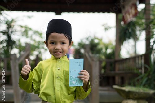 A Malay Boy In Malay Traditional Cloth Showing His Happy Reaction After Received Money Pocket During Eid Fitri Or Hari Raya Celebration Stock Photo Adobe Stock