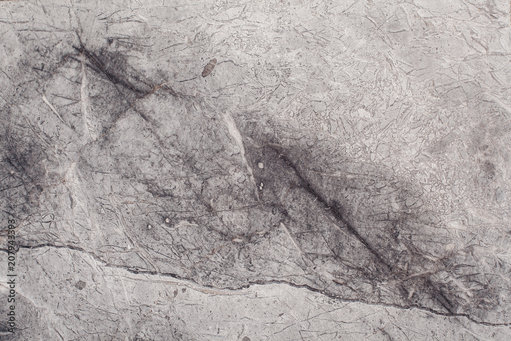 Naklejka premium Fragment of stone texture with scratches and cracks. Natural Background.