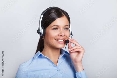 customer support phone operator in headset, with blank copyspace area for slogan or text message, over grey background. Consulting and assistance service call center.