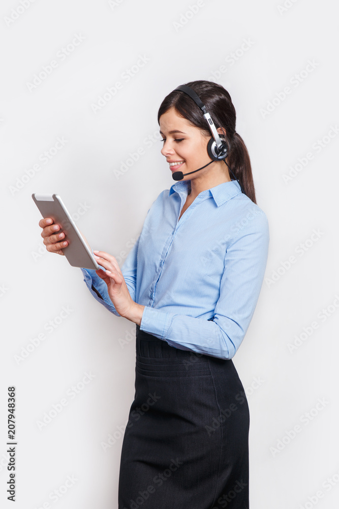 customer support phone operator in headset, with blank copyspace area for slogan or text message, over grey background. Consulting and assistance service call center. customer support phone operator in headset, with blank copyspace area for slogan or text message, over grey background. Consulting and assistance service call center.