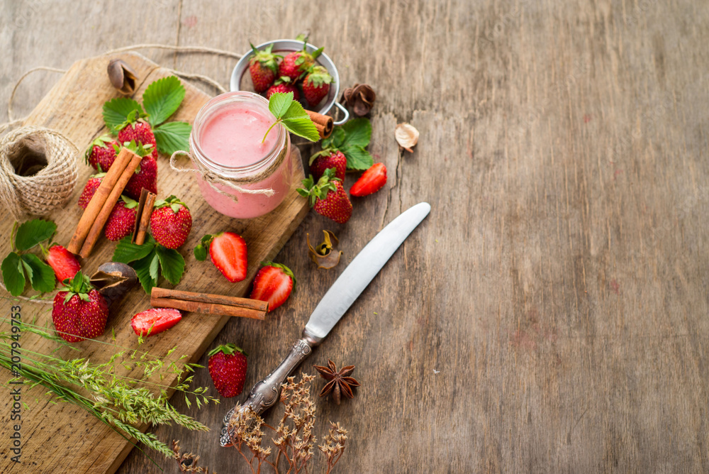 Strawberry smoothies in glass with many strawberries on wooden background. Top view. Copy space Strawberry smoothies in glass with many strawberries on wooden background. Top view. Copy space