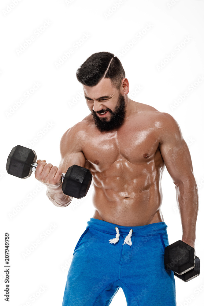 muscular man doing exercises with dumbbells.