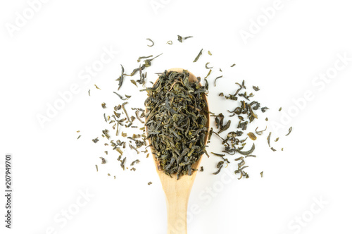 Jasmine green tea in wood spoon with on white background top view (flat lay), fresh whole loose leaves, floral flavour for beverage enjoyment during tea time or meal