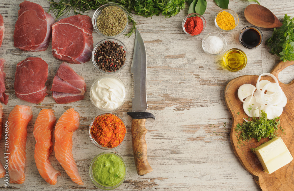 Sous vide. Beef, salmon, spice, greens on wooden table top as ingredients for cooking at low temperatures. Sous vide. Beef, salmon, spice, greens on wooden table top as ingredients for cooking at low temperatures.