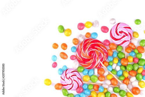 Multicolored lollipops and round candies on a white background. Top view. Isolated.