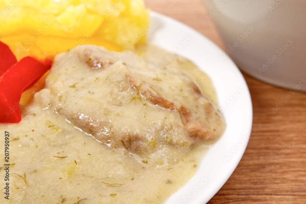 Seitan with dill sauce and potatoes on a table Seitan with dill sauce and potatoes on a table