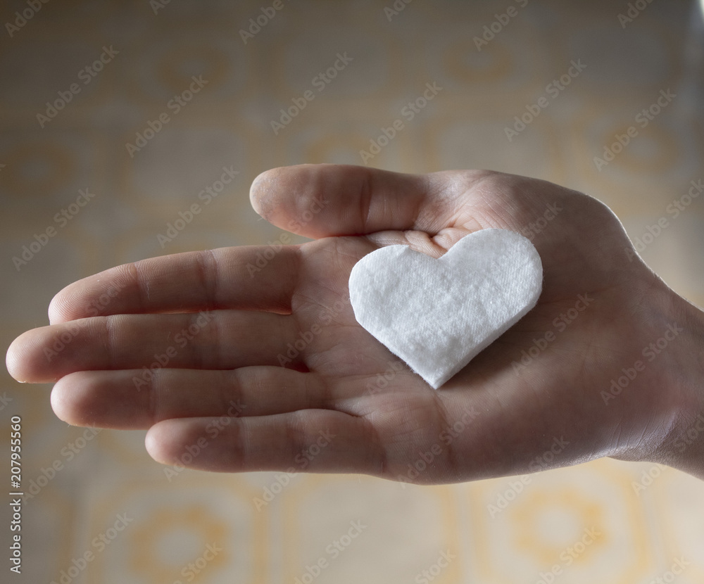 Fototapeta premium White Heart in female hand 